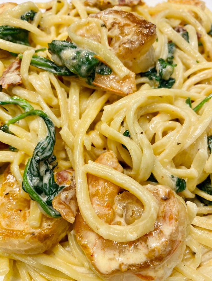 pasta with shrimp and spinach on a white plate