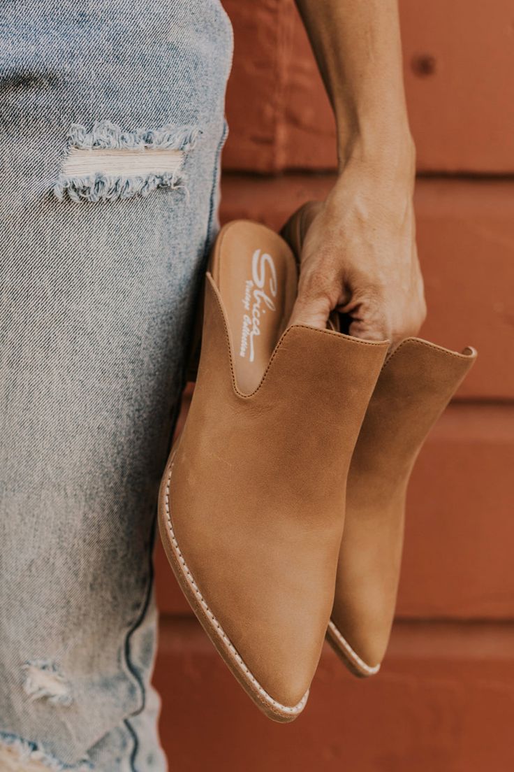 Stroll into your next meeting in the Thomaston Heeled Mule! These brown leather mules have a stacked heel and pointed toe. Notches on each side of the top keep it stylish but fierce! Need to clean your mules? Check out our blog on cleaning leather shoes! Leather 2 1/5" heel Cleaning Leather Shoes, Cleaning Leather, Platform Slip Ons, Floral Scrunchie, Heeled Mule, Athleisure Tops, Shoes Leather, Leather Mules, Stacked Heel