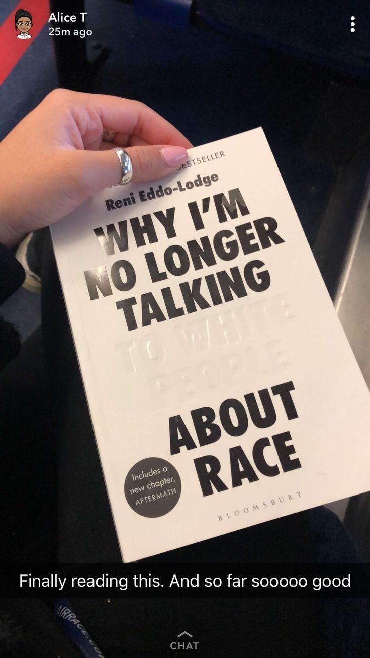 a person holding up a book with the title why i'm no longer talking about race