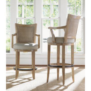 two chairs sitting next to each other on top of a carpeted floor in front of a window