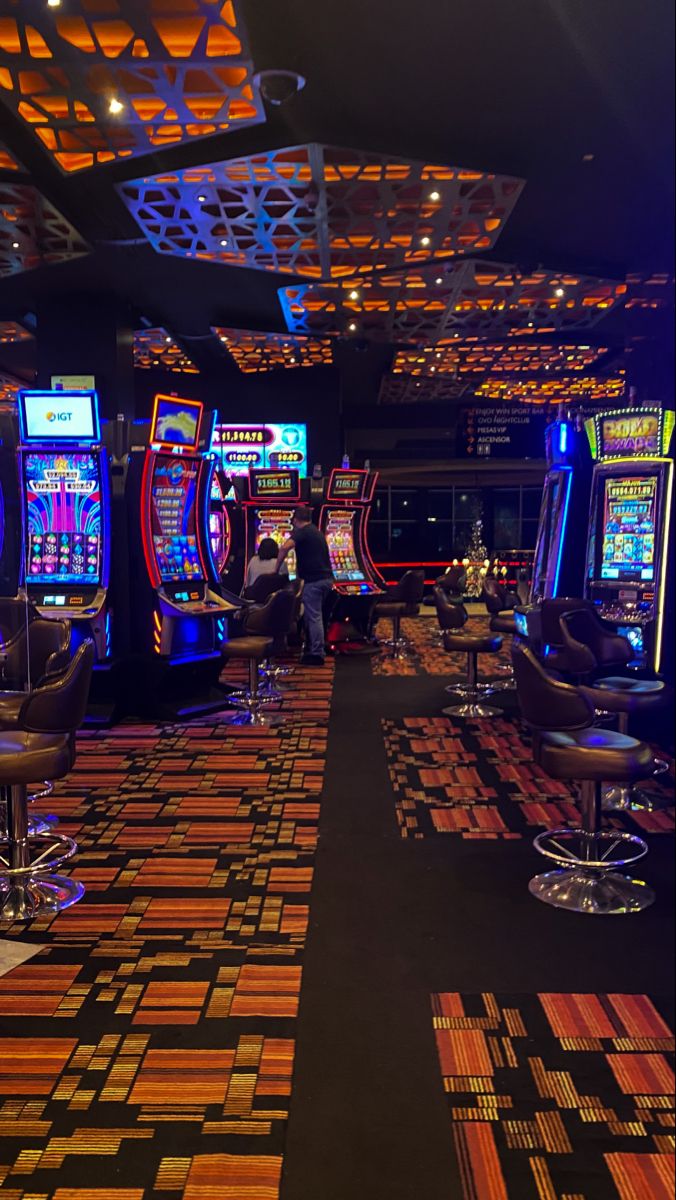 a casino room filled with lots of slot machines