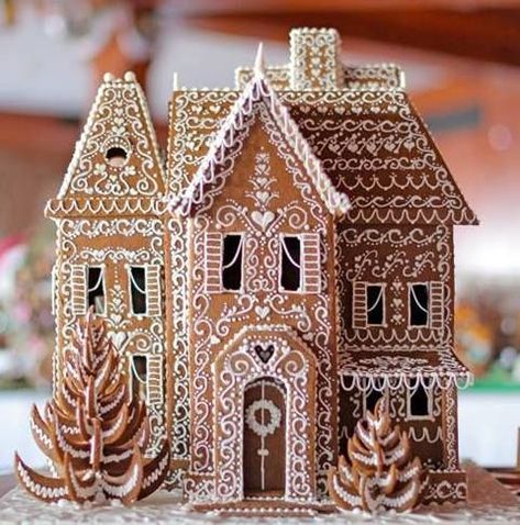 a gingerbread house is decorated with icing and sprinkles for the holiday season