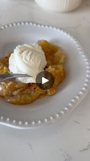 a piece of pie on a plate with a fork in it and whipped cream on top