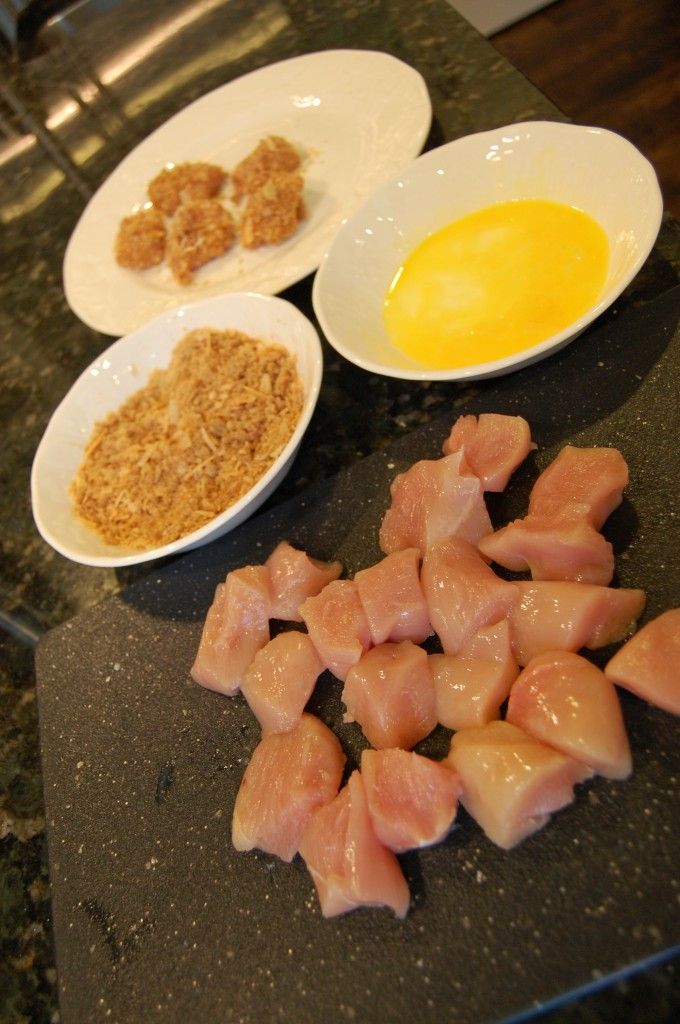 several plates with different types of food in them on a counter top, including eggs and meats