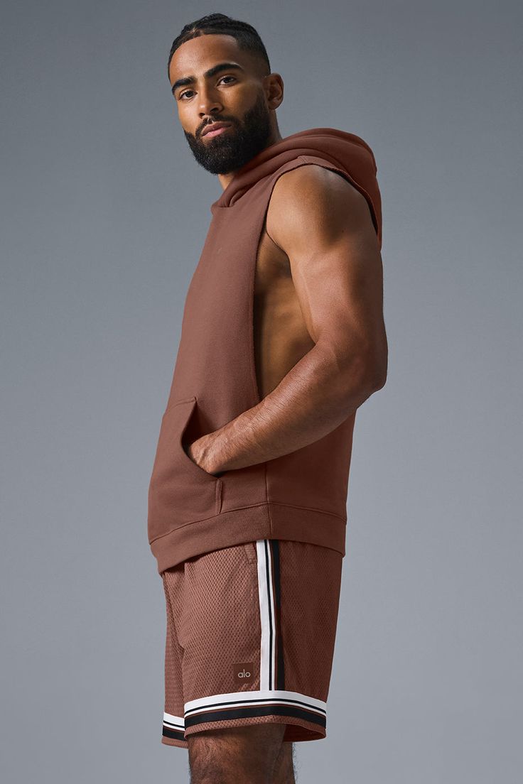 Stay cozy without sacrificing style in the Renown Sleeveless Hoodie. It has deep armholes, a kangaroo pocket, and a laid-back cut. And wait till you feel the Alo signature Renown fabric—it's smooth on the outside, a little fleecy on the side, and heavyweight for a just-right drape. Add shorts and you’re covered from the gym to the street. Sleeveless Fall Activewear For Workouts, Sleeveless Activewear For Fall Workout, Fall Sleeveless Workout Activewear, Brown Sleeveless Activewear For Sports, Brown Sleeveless Activewear For Workout, Brown Sleeveless Athleisure Activewear, Sporty Brown Hoodie For Loungewear, Brown Sleeveless Workout Top, Sporty Sleeveless Alo Yoga Tank Top