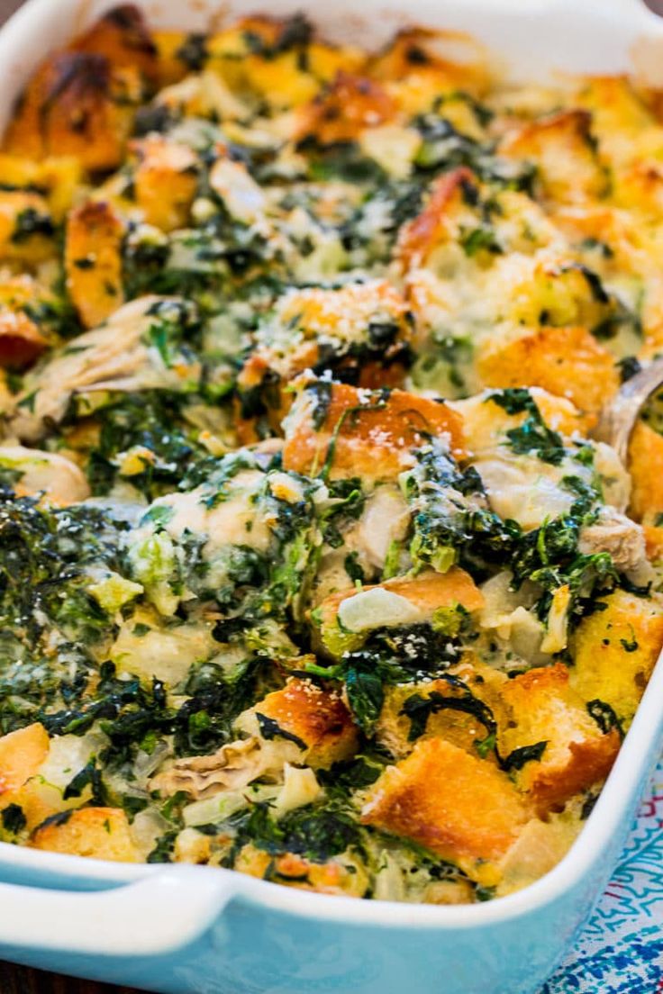 a casserole dish with chicken, spinach and cheese