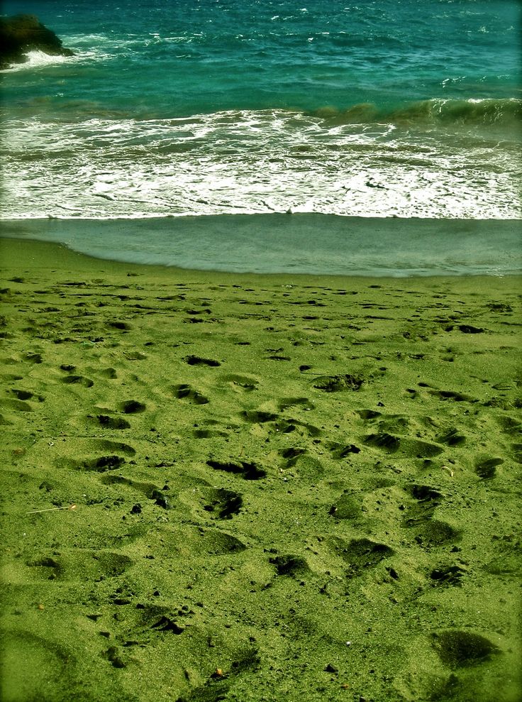 some footprints in the sand by the water