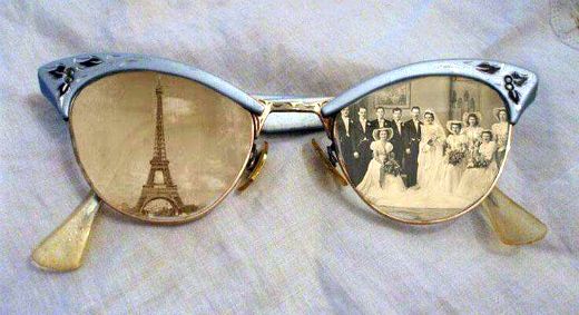 a pair of sunglasses with an image of the eiffel tower reflected in them