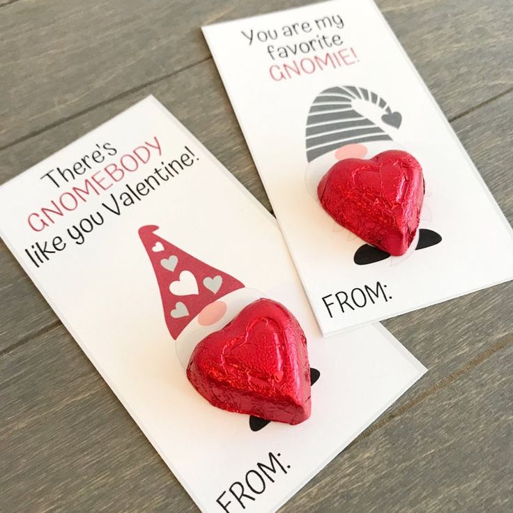 two valentine's day cards with red heart shaped candies