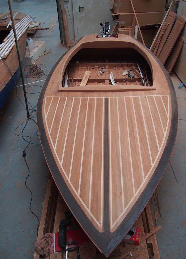 a wooden boat being built in a workshop