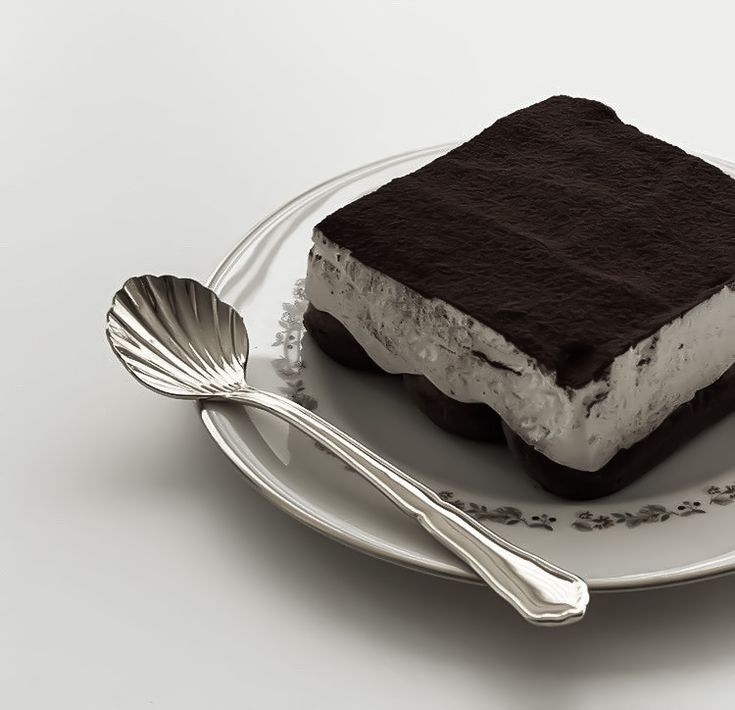 a piece of ice cream cake on a plate with a spoon