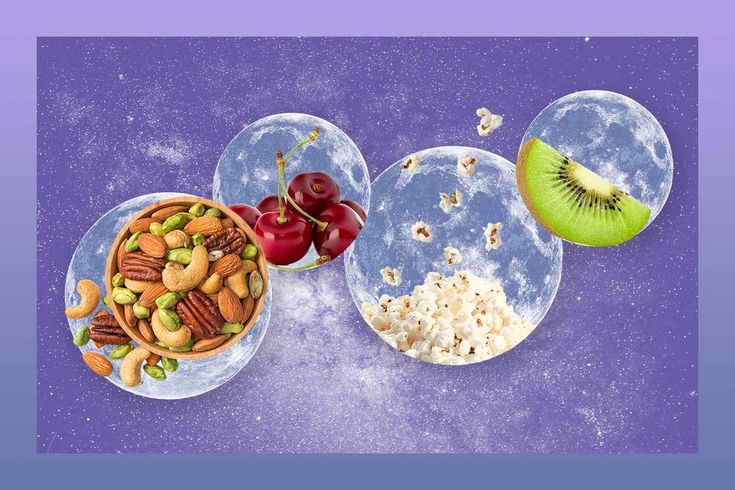 three plates filled with different foods on top of a purple background and one plate has fruit, nuts, and other food items