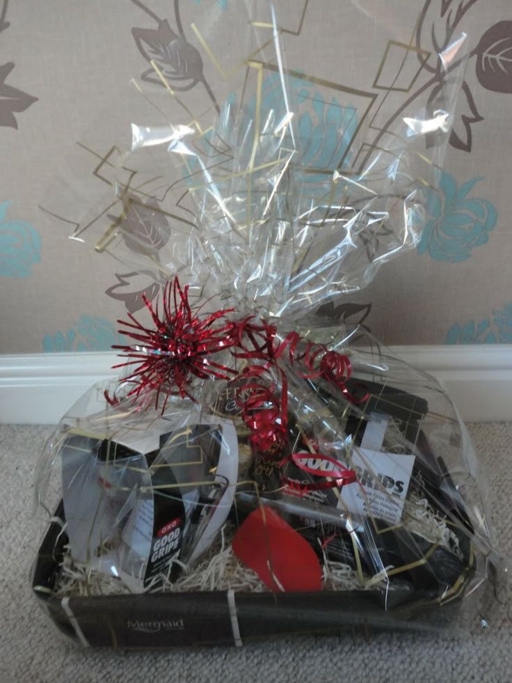 a basket filled with assorted items on top of a carpeted floor next to a wall