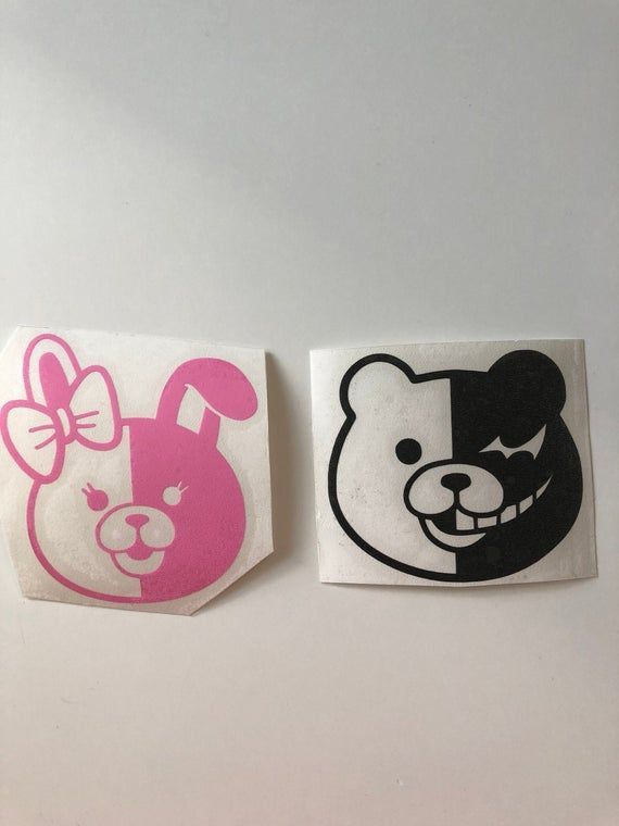 two stickers depicting cartoon animals on white paper with pink and black design, one has a bear head