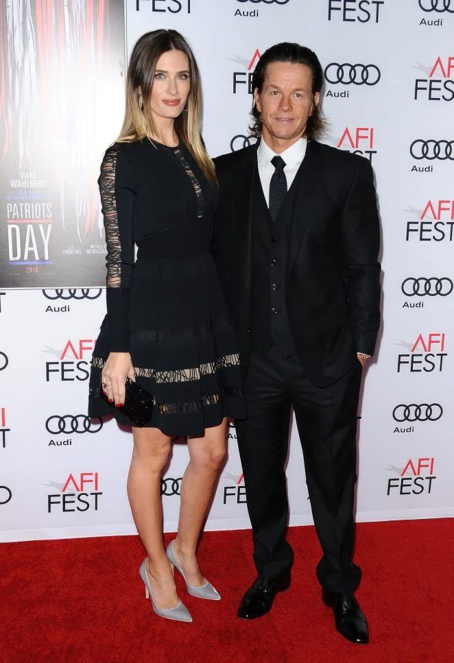 a man and woman standing next to each other on a red carpet at an afi fest event