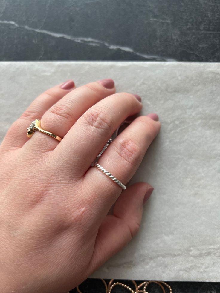 This twist dainty band is a must for any ring collection. It is simple yet stunning. Wear it on it's own or stacked with some simple bands. size Inclusive! available in sizes 3-15. note this lyric is soldered closed! Made with 14k gold, or sterling.  Hypoallergenic, the hand-shaped ring is made with high quality 14k gold fill metal that is the ideal solution for sensitive skin and will last for years to come. Gold-fill material contains 100x more gold than the microscopic film found on gold plated material. You can wear your gold-fill jewelry daily without having to worry about it losing its shine, chipping, or flaking. Each item is handmade and made to order, so please allow for slight variation. Orders typically ship within 7-10 business days. PLEASE CONTACT ME  prior to purchase if your Dainty Adjustable Stackable Toe Rings, Adjustable Hypoallergenic Stackable Rings For Everyday, Hypoallergenic Adjustable Stackable Rings For Everyday, Minimalist Stackable Adjustable Midi Rings, Minimalist Adjustable Stackable Midi Rings, Adjustable Stackable Minimalist Midi Rings, Stackable Twisted Rings For Promise, Modern Twist Stackable Rings For Promise, Modern Twist Stackable Twisted Promise Rings