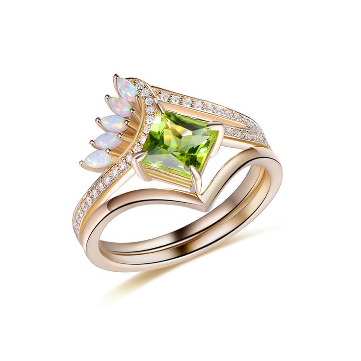 a gold ring with an opal and diamond set in the shape of a leaf