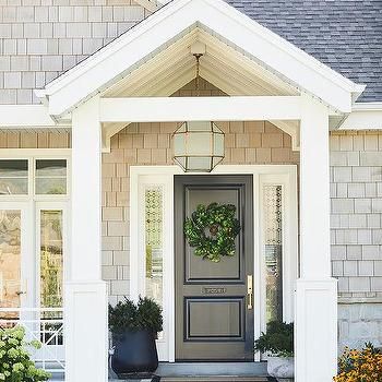 a house with a gray front door and white trim