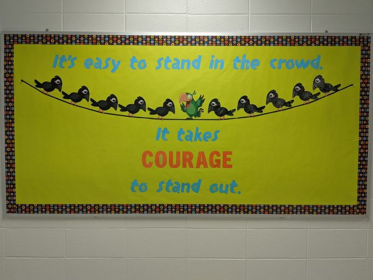 a bulletin board with birds sitting on a line in front of the words it takes courage to stand out