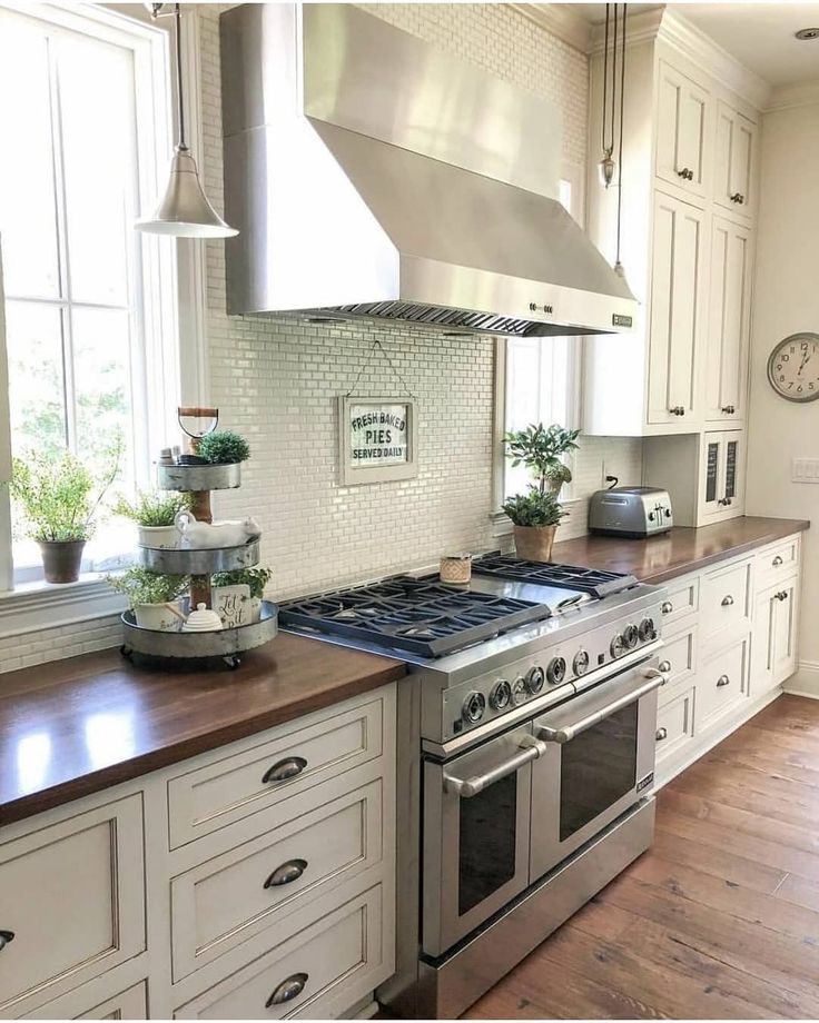 a kitchen with an oven, stove and counter tops in white painted wood flooring