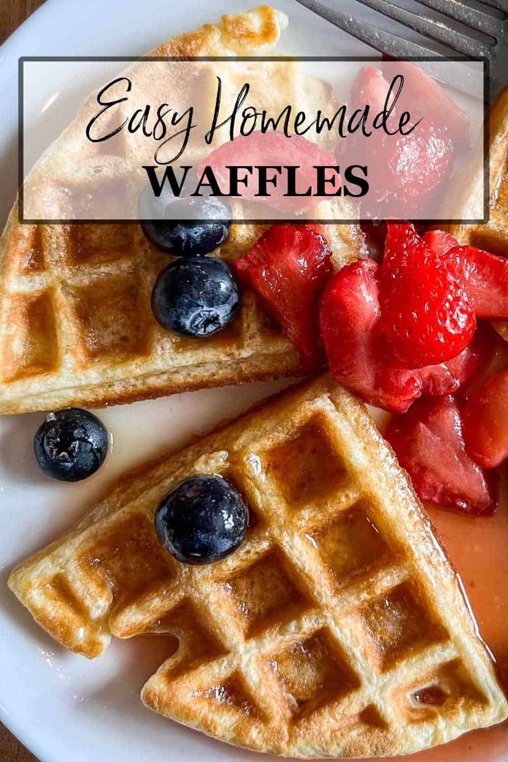 waffles with syrup and strawberries on a white plate next to a fork