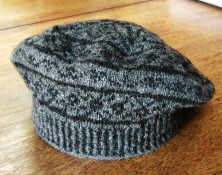 a gray hat sitting on top of a wooden table