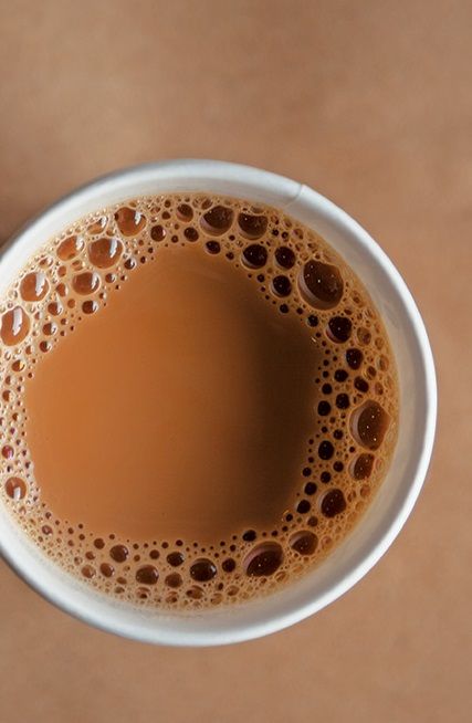 a white cup filled with liquid on top of a table