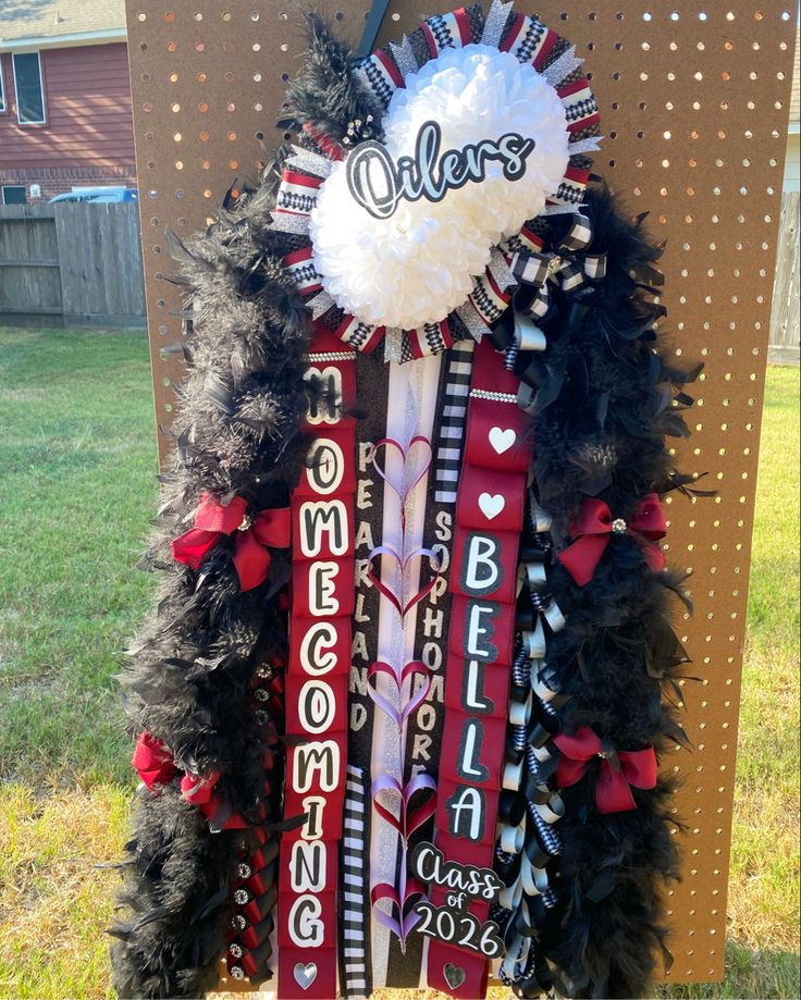 a sign with some ribbons on it in front of a building that says olelers