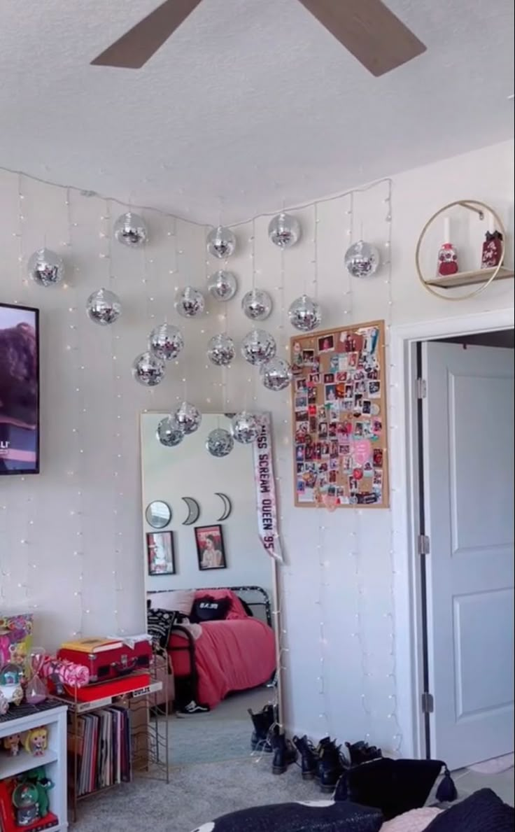 a room filled with lots of clutter and decorations on the wall next to a ceiling fan