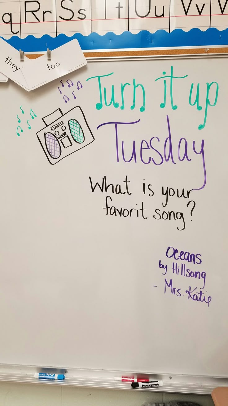 a white board with writing on it and magnets attached to the back of it that says, turn it up tuesday what is your favorite song? oceans by hillsong