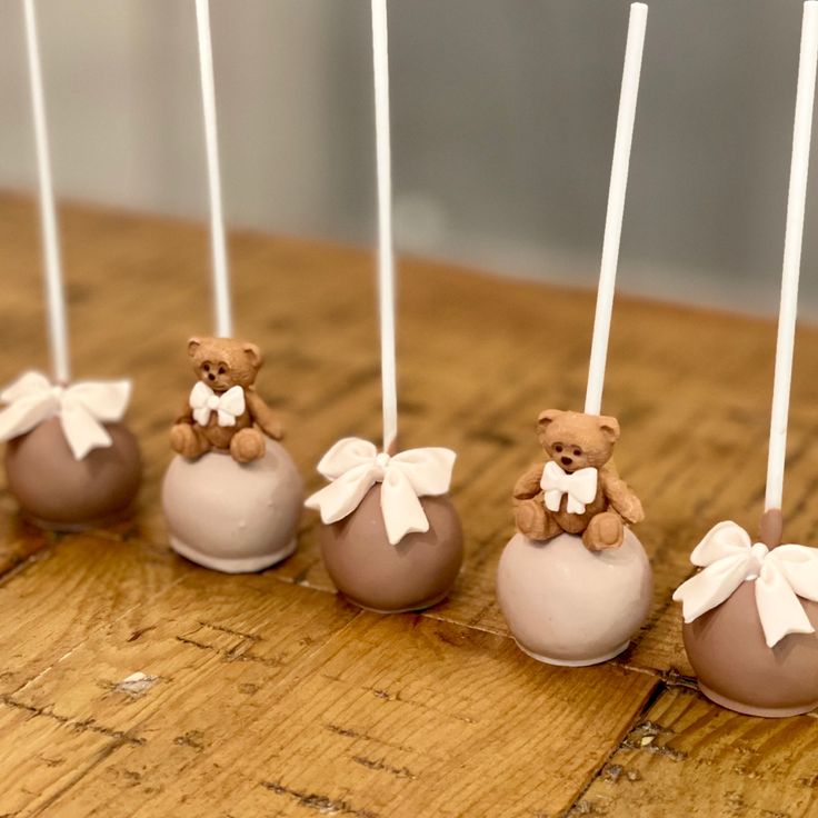 chocolate candies with teddy bears in them on a wooden table