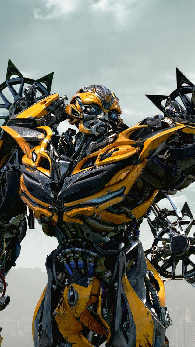 a large yellow and black robot standing next to each other