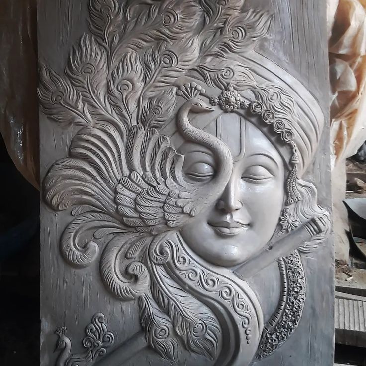 an intricately carved statue with a woman's face