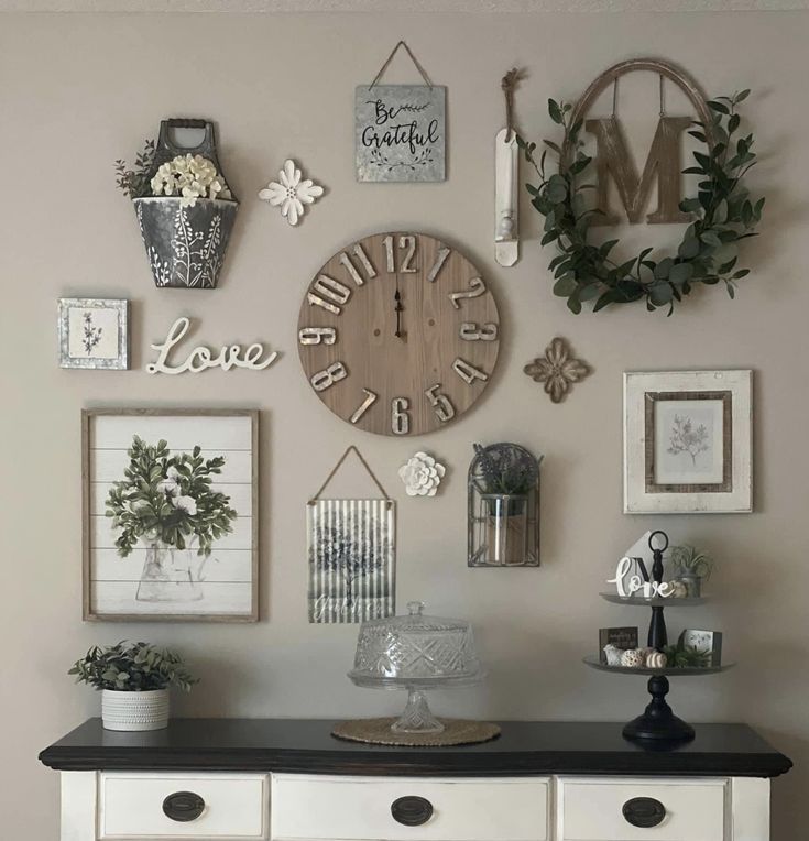 a white dresser topped with lots of pictures and clock on it's side wall