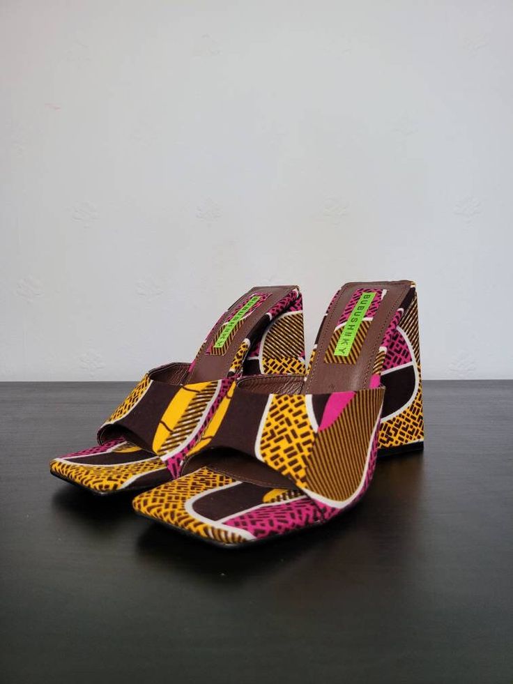 Bold lines, bright colours and a funky heel. This is Margaret's Mule. The shoe that turns heads and pulls compliments in abundance. Only FOUR pairs available!! Casual Multicolor Slip-on Heels, Trendy Multicolor Block Heel Sandals, Multicolor Heels With Wooden Heel For Summer, Multicolor Sandals With Padded Block Heel, Trendy Multicolor Slip-on Heels, Multicolor Block Heel Sandals With Padded Heel, Trendy Multicolor Heels With Padded Heel, Retro Multicolor Open Toe Heels, Multicolor Casual Heels With Open Heel