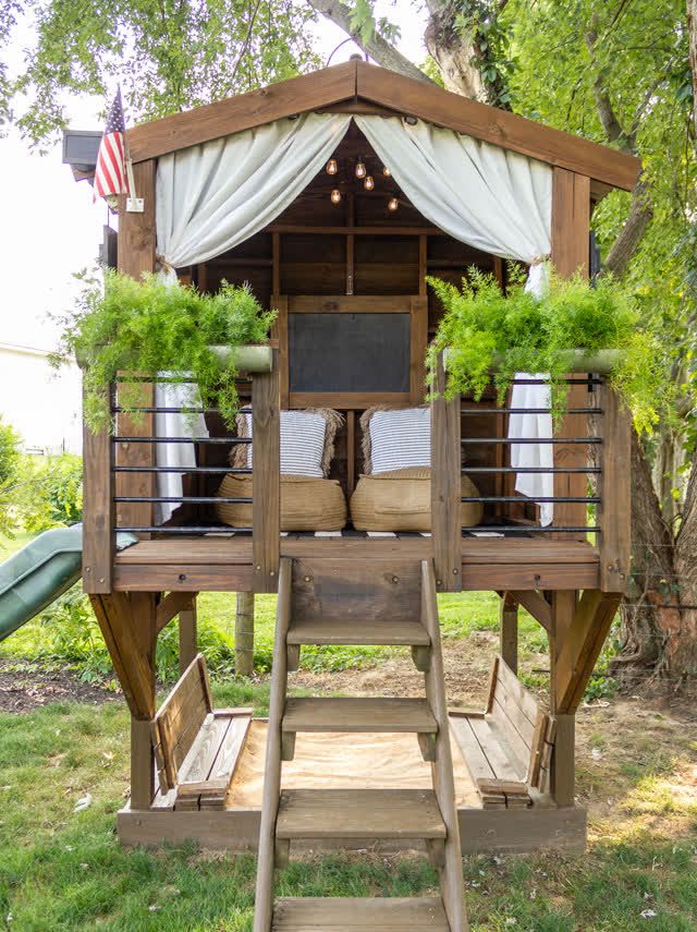 a small wooden structure with plants on it