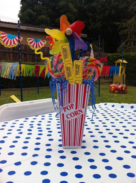 a table topped with a cup filled with candy