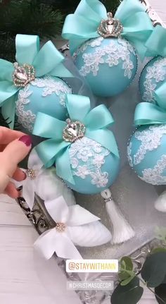 some blue and white ornaments with bows on them