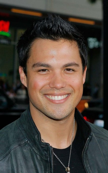 a smiling man wearing a black leather jacket