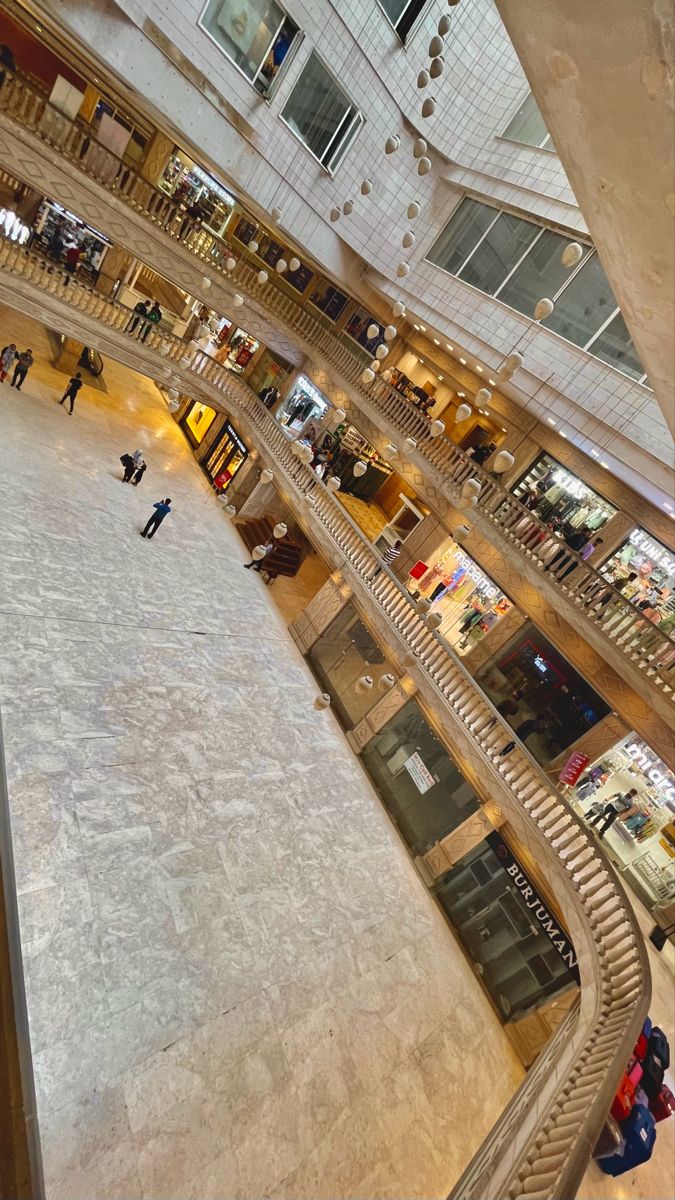 an overhead view of people shopping in a large building with many floors and balconies