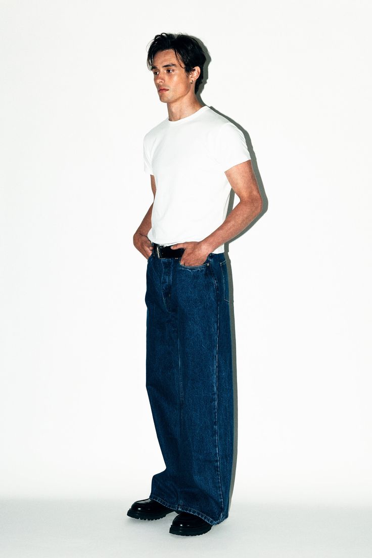 A pair of relaxed straight-leg jeans inspired by the boyish minimalism of the 90's. Designed to be perfectly roomy around the leg without looking overly baggy. Canon is a go-with-everything pair of forever denim. Canon fits loose but not baggy. A more relaxed fit than our Rodeo Classic Straight Leg Jeans but less baggy than our Laurel Wide-Leg Jeans. Early 2000s Fashion Photoshoot, Straight Jeans Mens, 90s Calvin Klein Ads Men, Male Fashion Colorful, Wide Fit Jeans Outfit Men, Dark Wash Blue Jeans Outfit, Men’s Fashion Jeans, White Longsleeves Outfit For Men, Wide Jeans Outfit Men