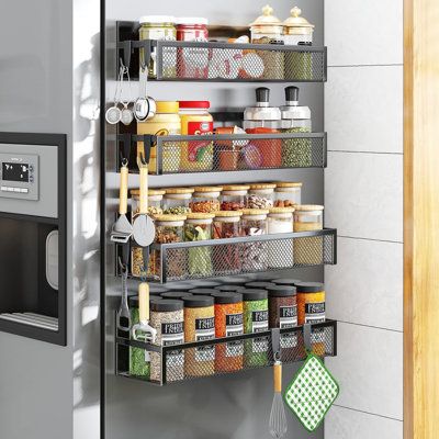 an organized pantry is shown in the corner of a kitchen with stainless steel shelving