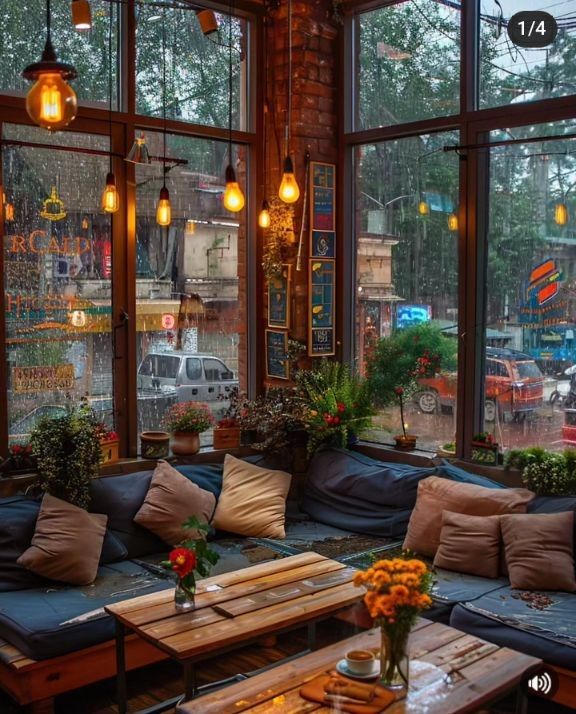 a living room filled with lots of furniture and windows covered in hanging lights next to each other