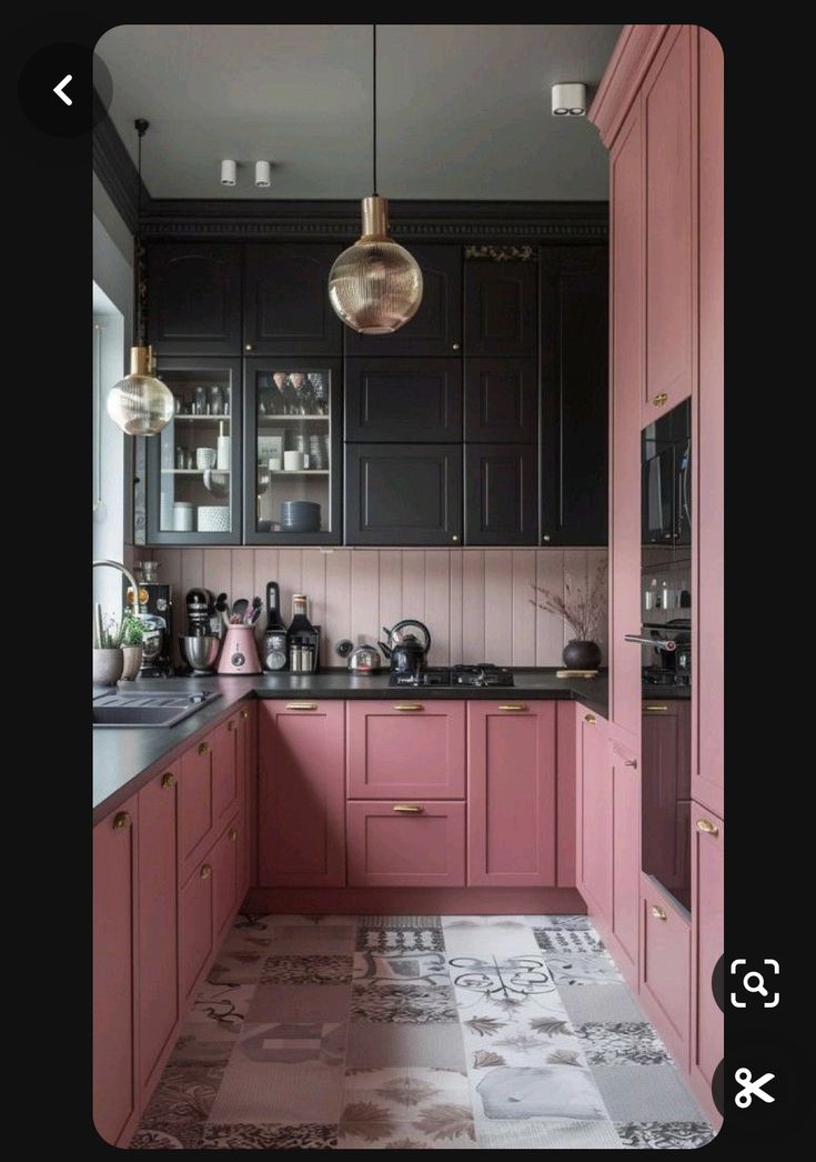 a kitchen with pink cabinets and black counter tops in the center is an area that looks like it could be used as a dining room