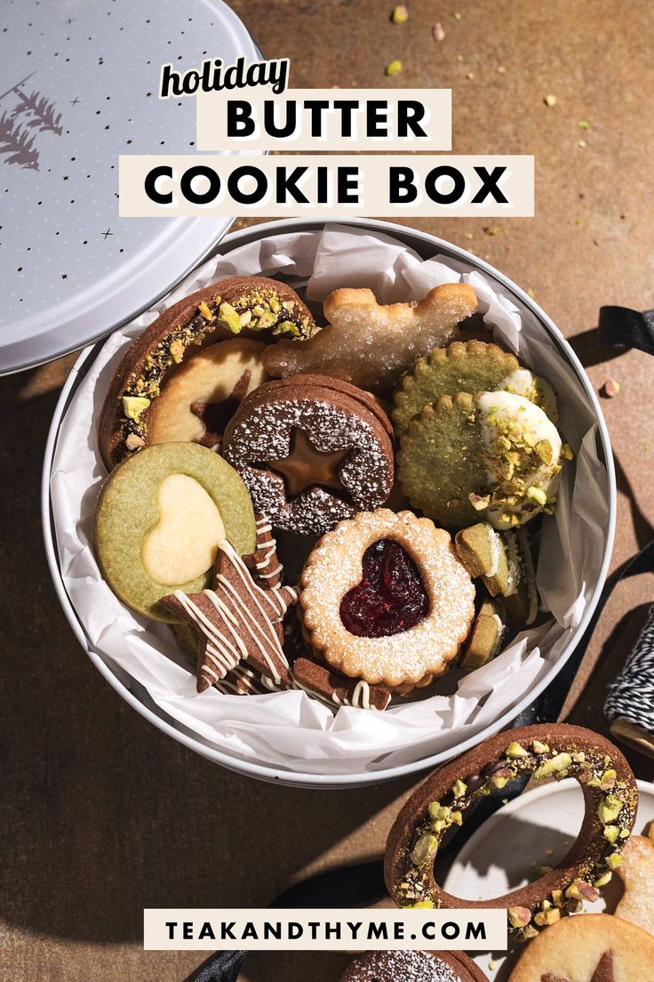 an overhead view of cookies in a tin with the words, holiday butter cookie box