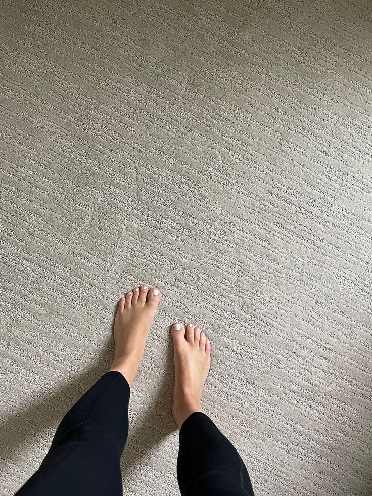 a person standing on the floor with their feet up