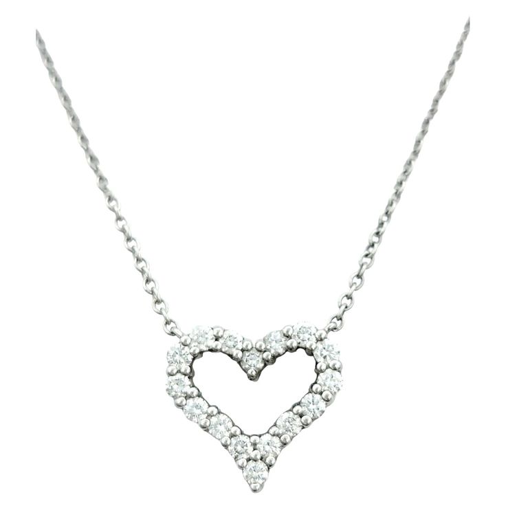 This petite Tiffany & Co. pendant necklace, set in polished platinum, is an embodiment of timeless elegance. The pendant takes the form of an open heart, adorned with a mesmerizing array of diamonds, adding a touch of brilliance to its delicate silhouette. The open design of the heart symbolizes both sophistication and enduring love. Suspended gracefully from a cable chain, the pendant remains stationary, allowing it to delicately rest against the wearer's décolletage. The platinum setting adds a luxurious backdrop to the sparkling diamonds, creating a piece that effortlessly transitions from casual to formal occasions. This Tiffany & Co. pendant necklace is a classic and versatile accessory, making it a cherished addition to any fine jewelry collection. This piece is in very good estate c Louis Comfort Tiffany, Elsa Peretti, Tiffany And Co, Open Design, Fine Jewelry Collection, Open Heart, Sparkle Diamonds, Heart Pendant Necklace, Tiffany & Co.