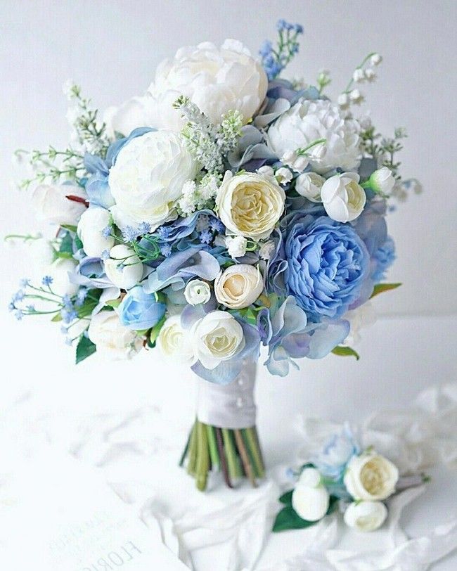 a bridal bouquet with blue and white flowers