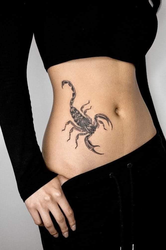 a woman with a scorpion tattoo on her stomach