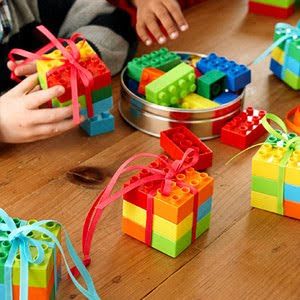 children playing with legos on the table in front of their gifts and other toys